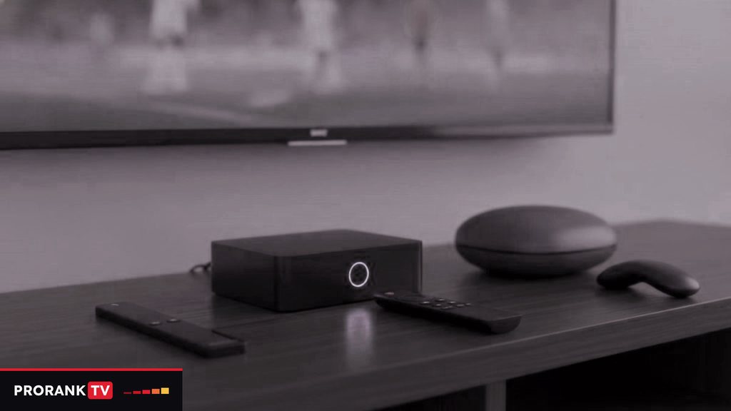 Cover for “Best IPTV box: choosing a streaming device for live TV and listening practice”: a set-top box, a round streaming box and a streaming stick with their remotes on a TV console