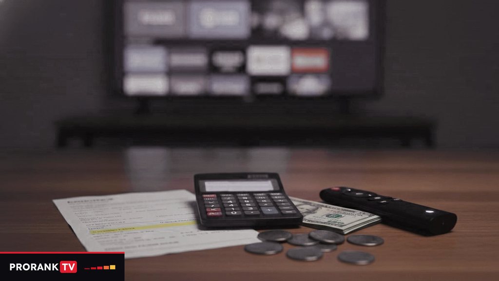 Cover for “How much does IPTV cost? Prices by term, screen count and goal”: a calculator with a blank display, banknotes, coins and a remote on a table in front of a television