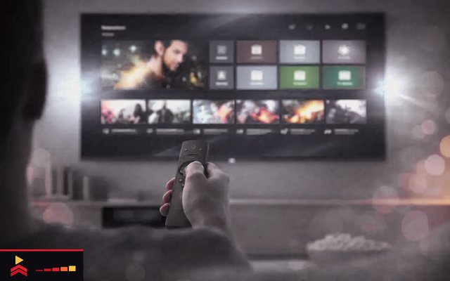 Cover for “IPTV glossary A to Z: from audio track to Xtream Codes”: a hand pointing a remote at a wall television that shows rows of titles